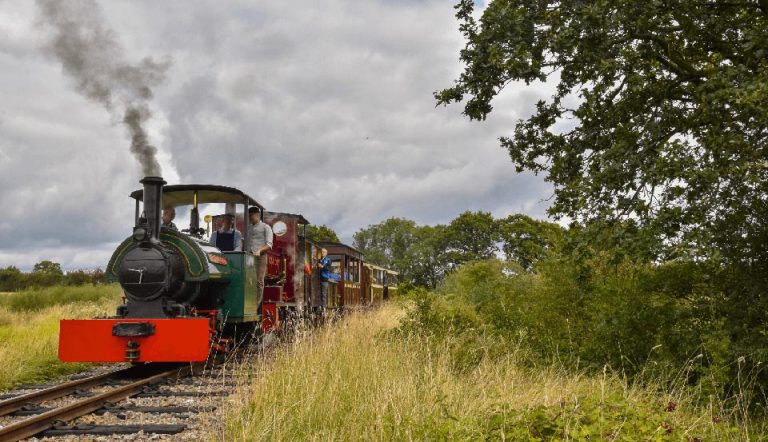 cloudy-day-dark-green-train-with-passengers
