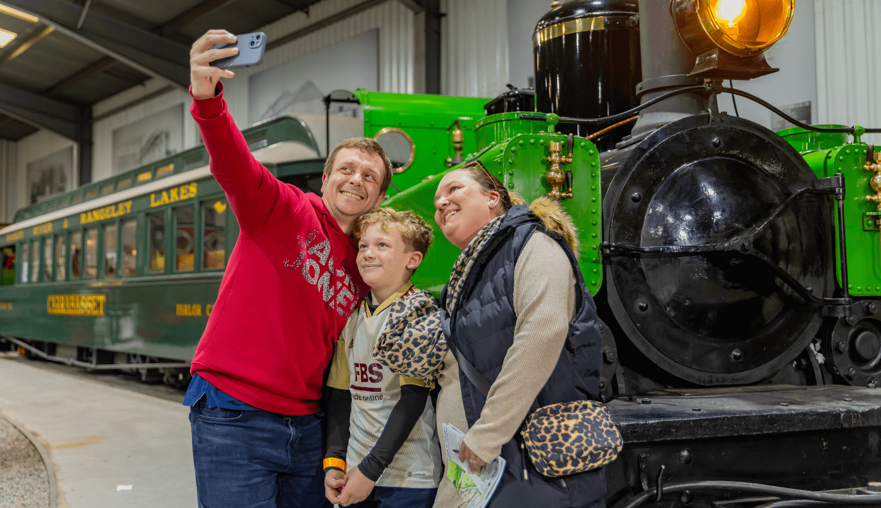 Family selfie in front of train and carriage