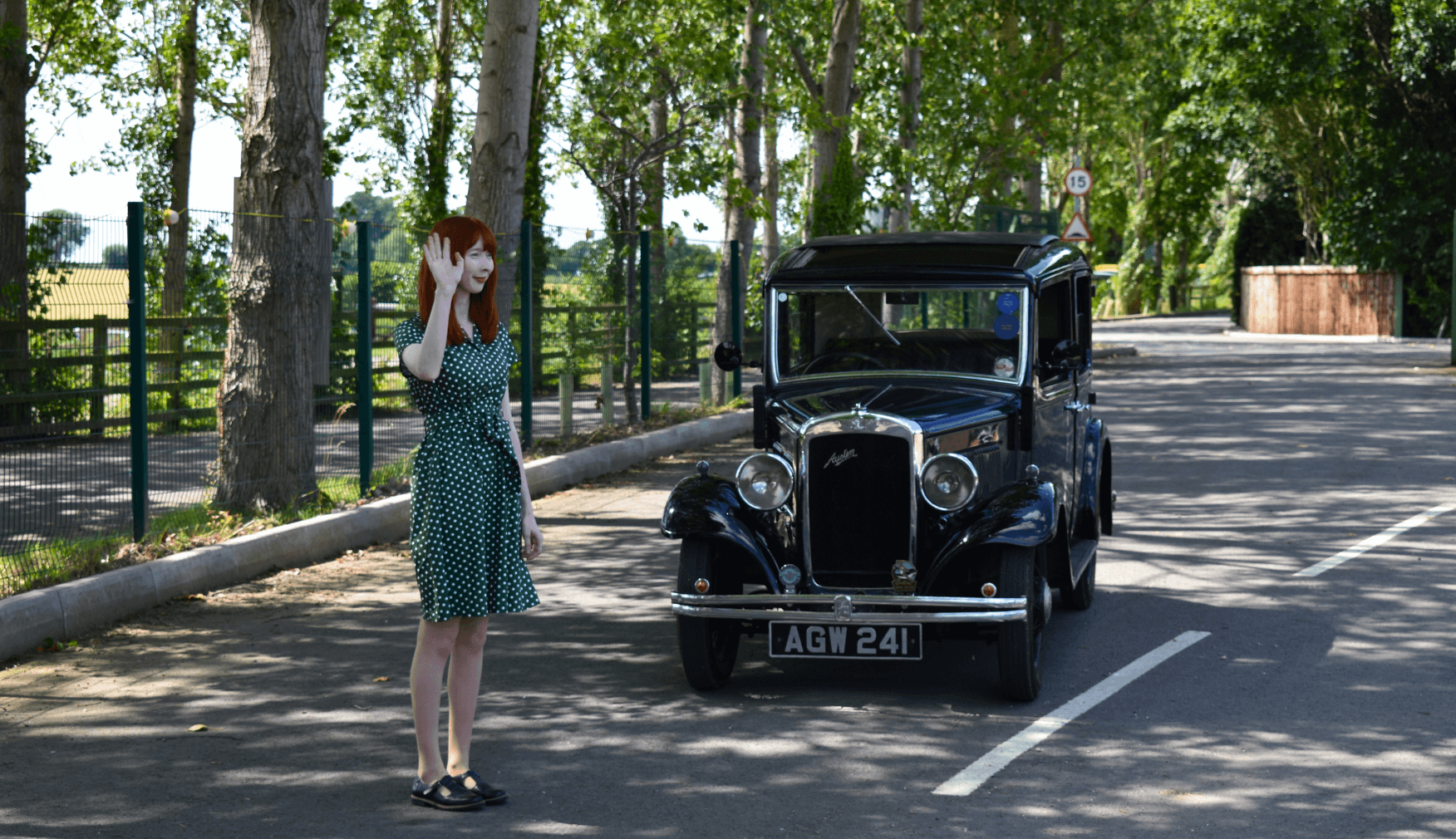 Lady stood by old car