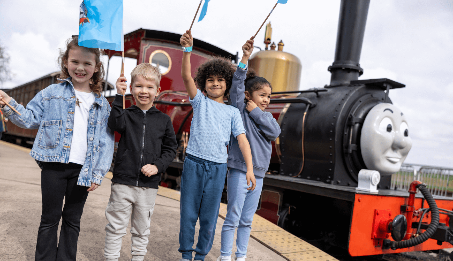 Children waving flags by James the Engine at Statfold