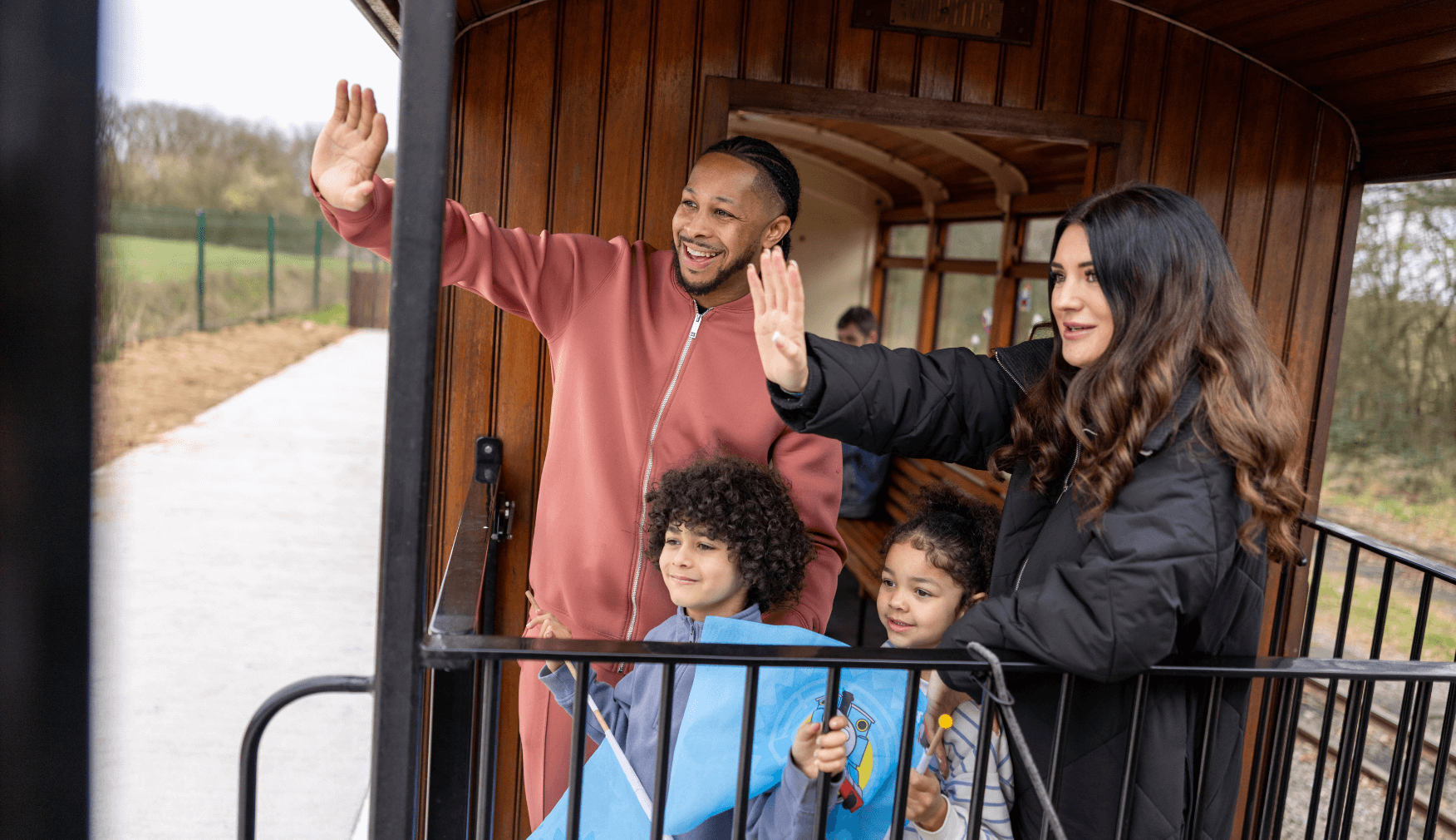 Family waving from the Train Balcony at Statfold