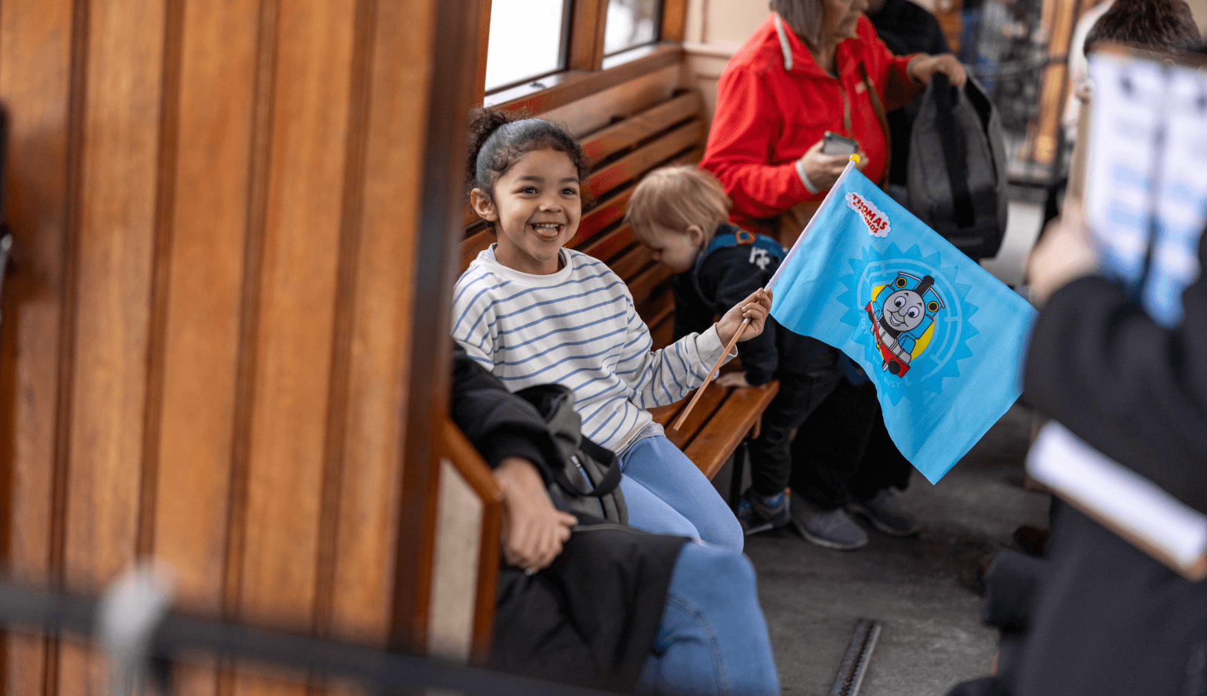 Girl waving flag on the train carriage at Day Out With Thomas