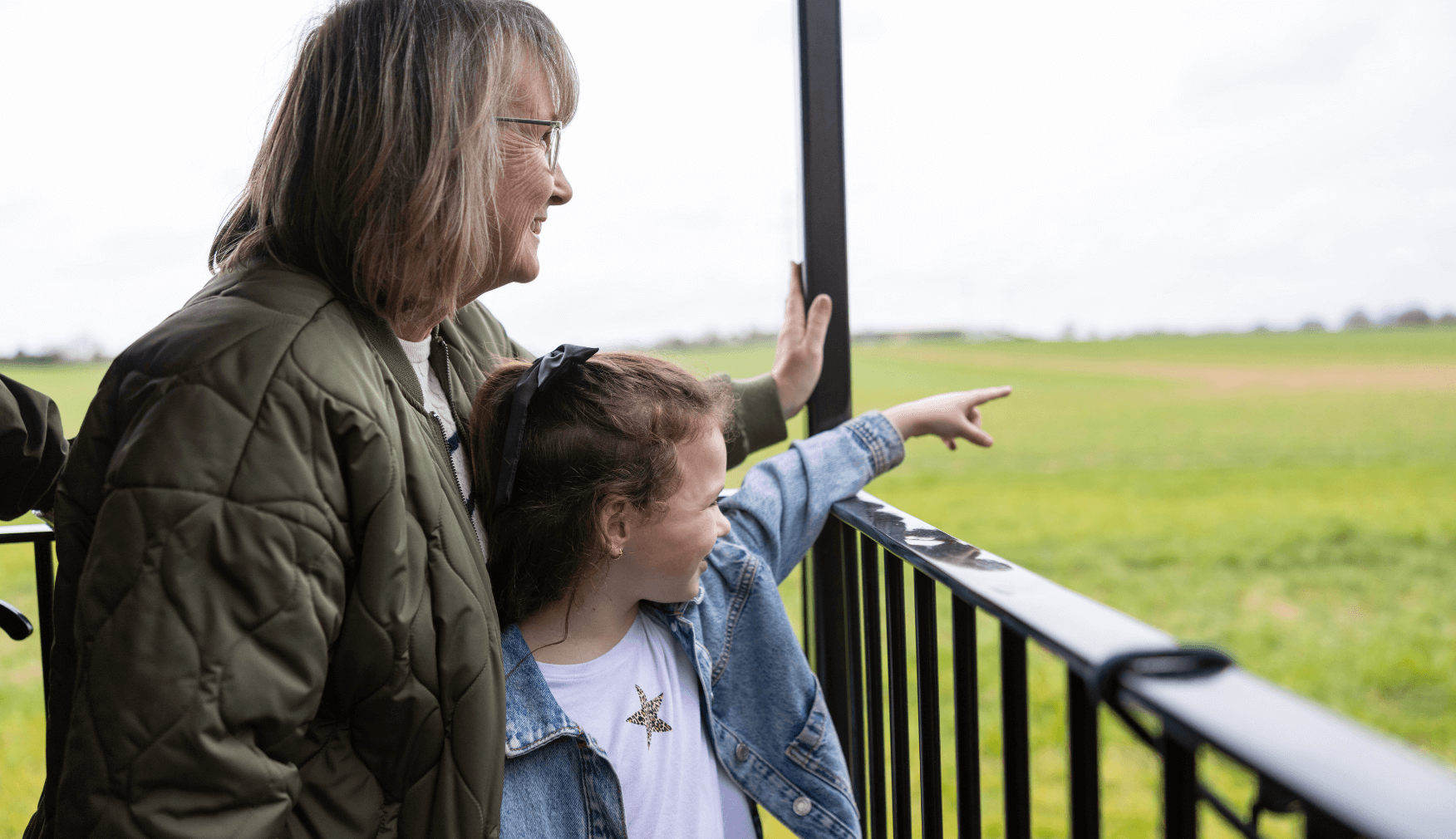 Grandma and Grandchild looking at the views from the steam train at Statfold
