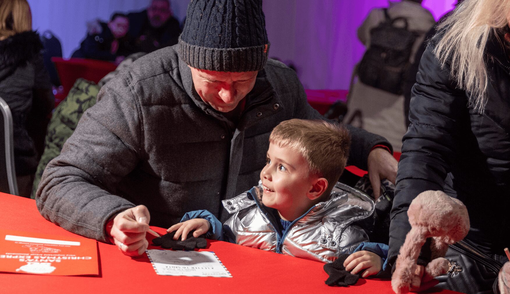 Dad and son writing letter to Santa