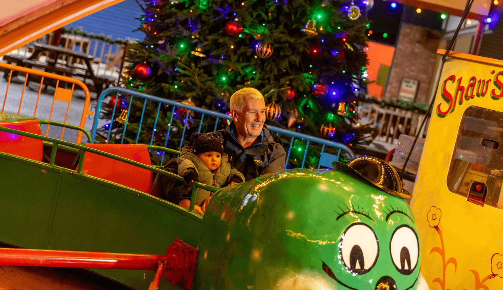 Grandad and baby on ride at Magical Santa Express